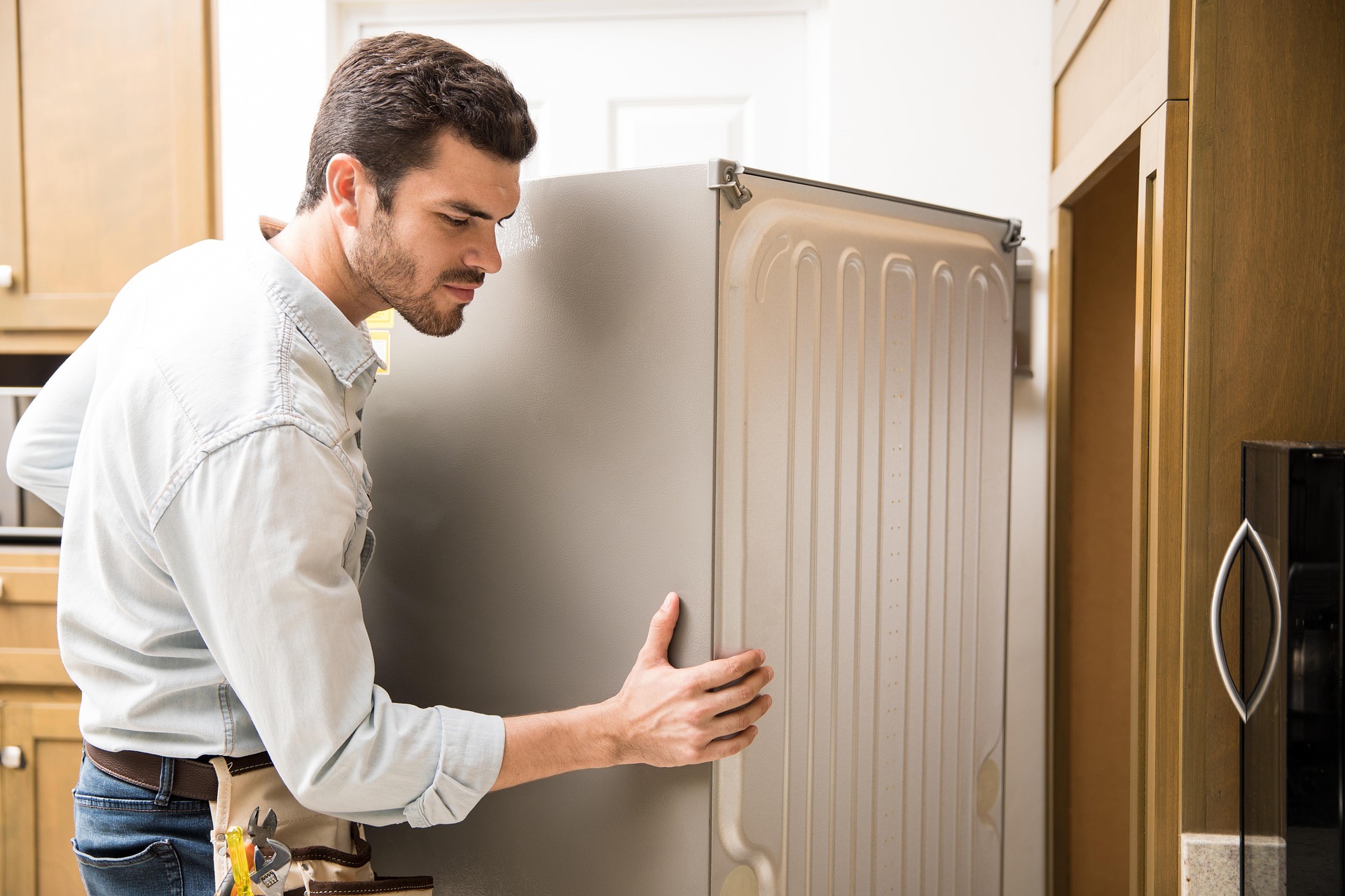 Professional appliance repair technician in Mysore working on a washing machine.